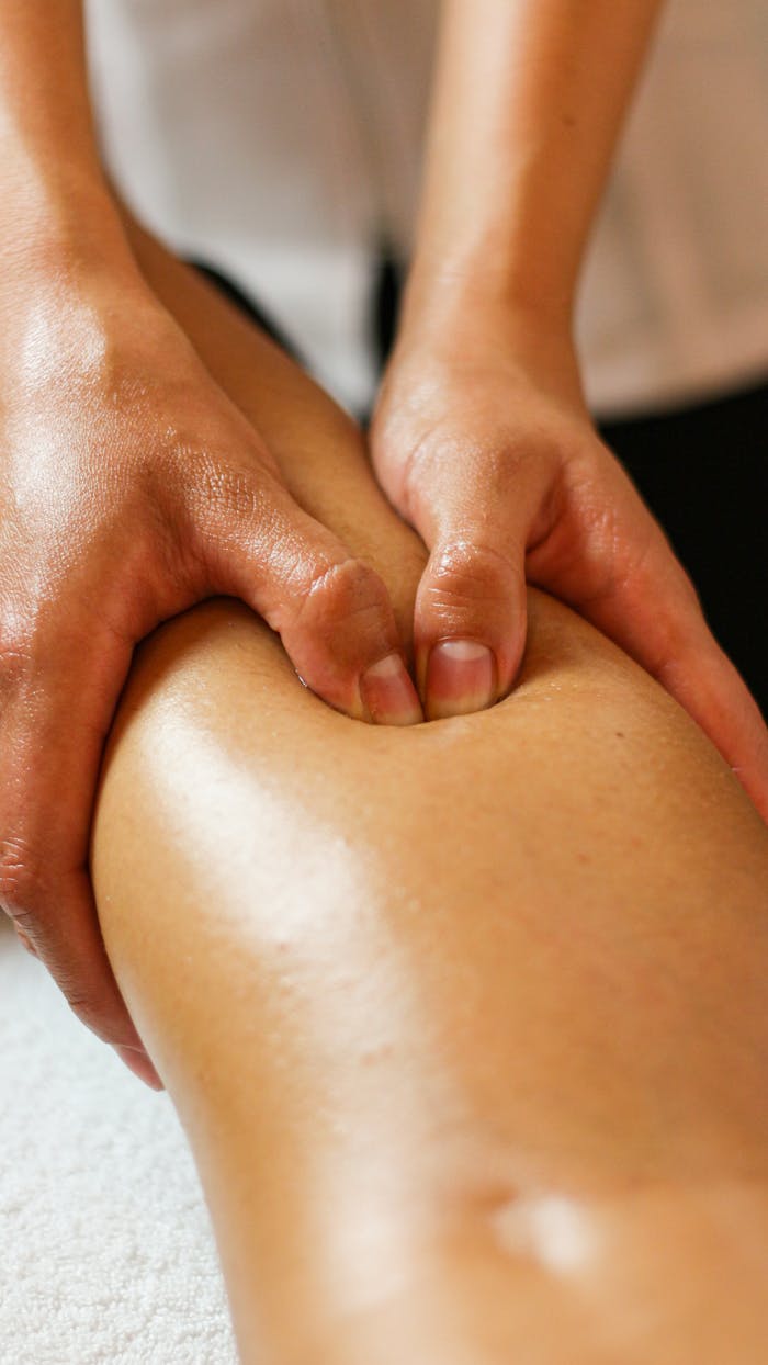Hands of a Person Pressing a Leg
